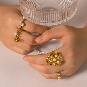 Set of 18K gold stainless steel pearl rings featuring irregular design on model hand