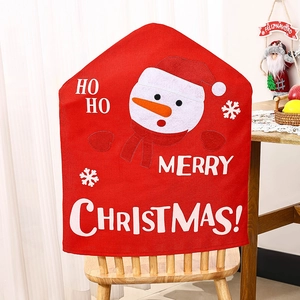 Detail of Christmas snowman chair cover with Ho Ho text in a cozy dining room setting