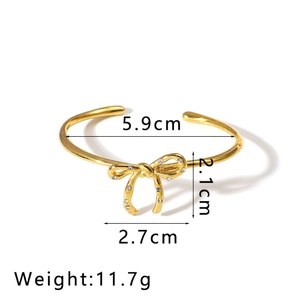 Detailed top view of 18K gold bow knot bangle with sparkling zircon stone inlay