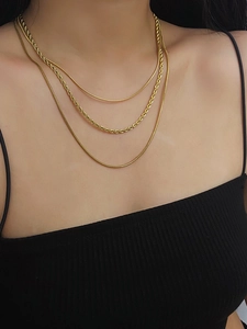 Detailed view of triple-layer 18K gold plated snake and twisted rope chain necklace