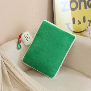 Green sherpa mahjong mahjong style plush pouch with cute character charm on sofa