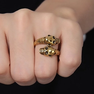 Golden double panther head open ring with detailed scale texture on model hand