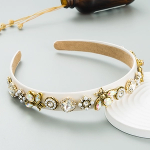 Detail of luxury bee headband with rhinestones, pearls and vintage gold floral accents