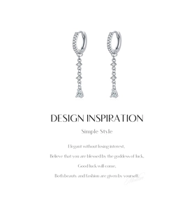 Macro detail of S925 sterling silver long tassel drop earrings with sparkling zircon stones