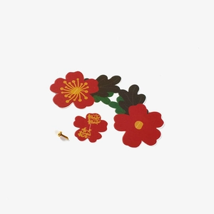 Detail view of red floral wedding gift box ornaments with gold Xi character and metal fastener