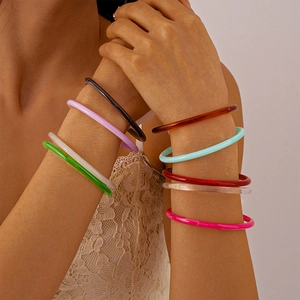 Colorful acrylic resin bangles stacked on model arm in vibrant candy shades