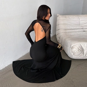 Detail of the backless design and sheer mesh patchwork on this black evening dress
