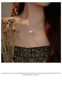 Close-up of S925 sterling silver necklace with a white shell flower and cubic zirconia