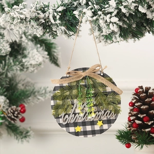 Close-up of a wooden buffalo check Christmas ornament with silver Merry Christmas lettering