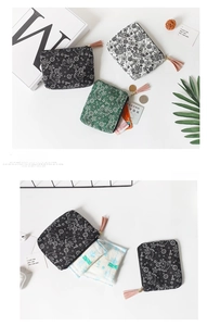 Detailed flat lay of mini paisley coin purses in black, white, and green with tassels