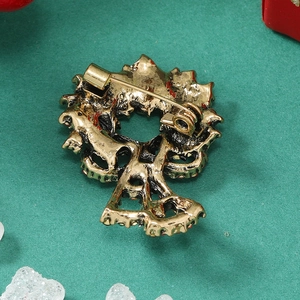 Macro view of Christmas wreath brooch back showing alloy pin closure and vintage gold finish