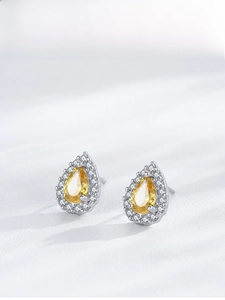 Close-up of S925 silver pear-cut yellow zircon stud earrings with halo diamonds