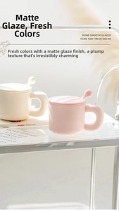 Detail of matte ceramic mug set with lid and spoon on a glass shelf in warm light