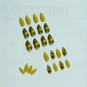 Matte mustard yellow almond press-on nails featuring realistic black butterfly designs