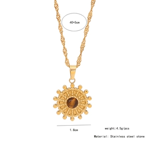 Detail showing 1.8cm sunburst tiger stone pendant on a 40+5cm gold stainless steel chain