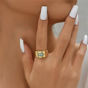 Gold-plated Evil Eye wide open ring with turquoise zircons worn on a model's finger