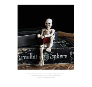 Macro detail of hand-painted skull figurine sitting on books with realistic bone texture