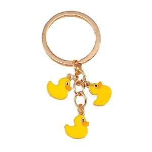 Golden metal keychain with three vibrant yellow duck charms on a star-shaped ring