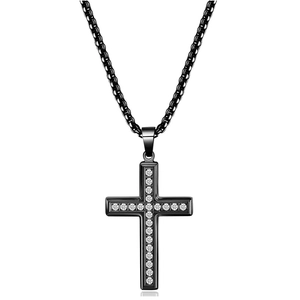 Black stainless steel cross necklace with inlaid crystals on a white reflective surface