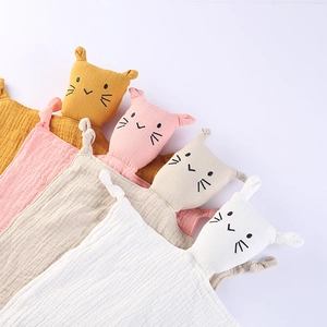 Set of four cotton muslin baby comforter blankets in soft yellow, pink, beige, and white