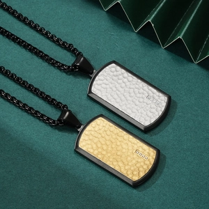 Two-tone hammered metal dog tag pendants in black and gold on sleek black chains