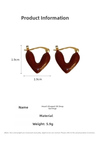 Detail view of burgundy heart-shaped oil-drip earrings with gold edges and dimensions