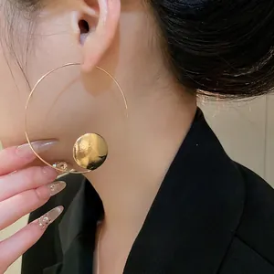 Minimalist gold geometric hoop earrings with hammered metal disc pendant for women