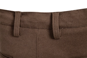 Detailed macro view of the brown trousers waistline showing belt loops and fine stitching