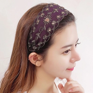 Diadema bordada violeta oscuro con cristales en una modelo para un estilo muy elegante