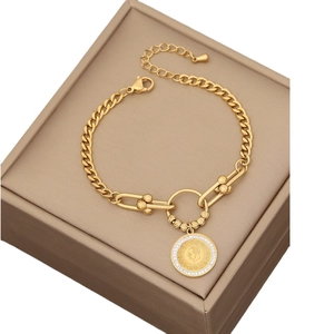 Gold stainless steel bracelet with coin pendant and crystal inlay on jewelry box
