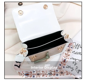 Detailed interior view of white crossbody bag with dual compartments and embroidered strap