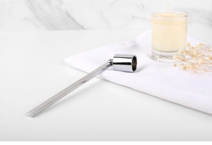 Close-up of a silver stainless steel candle snuffer with a long handle and bell head