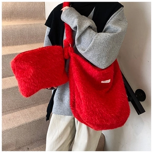 Detailed view of red plush tote bag set featuring fluffy texture and spacious shoulder strap