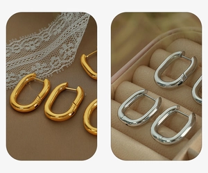 Detail view of U-shaped gold and silver plated titanium steel hoop earrings on display