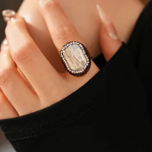 Vintage style gold-plated ring with oval mother-of-pearl center and halo rhinestone inlay