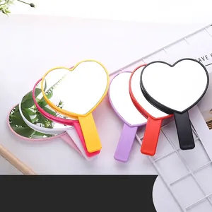 Cute heart-shaped handheld makeup mirrors in five colors with ergonomic handles