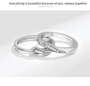Detail of interlocking couple rings with elegant silver finish and sparkling zircon inlay