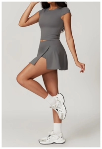 Detail of grey short sleeve sports top and tennis skirt with high stretch material