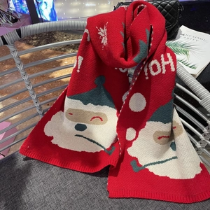 Close-up of red Christmas snowman knit scarf with HO HO text and snowflake pattern