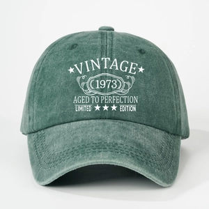 Detail of Vintage 1973 printed text on washed forest green baseball cap fabric