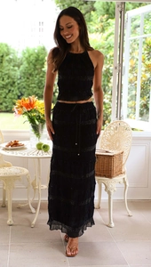 Detail of a black two-piece sleeveless chiffon set featuring pleated texture and airy long skirt