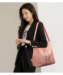 Pink large capacity fashion backpack detail featuring side storage pockets and wide straps