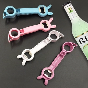 Four colorful bunny-shaped 4-in-1 jar openers in pink, blue, and white on a dark desk