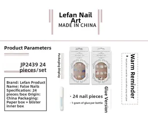Detailed view of blue and white geometric pattern fake nails with packaging and glue