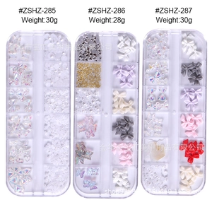 Three mixed nail art decoration sets in clear boxes with aurora rhinestones and resin bows