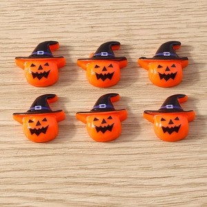 Flat lay of resin Halloween pumpkin charms with witch hats for DIY phone case decor