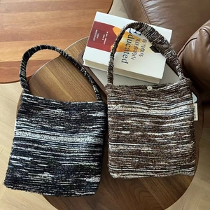 Retro knitted tote bags in black-white and brown stripes on a wooden table