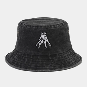 Detail of white hand embroidery on black washed denim bucket hat with stitched brim