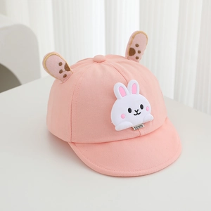 Detail of pink baby baseball cap featuring 3D rabbit ears and soft cotton fabric texture