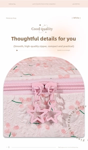 Detail view of pink floral quilted makeup bag with unique star-shaped zipper pulls